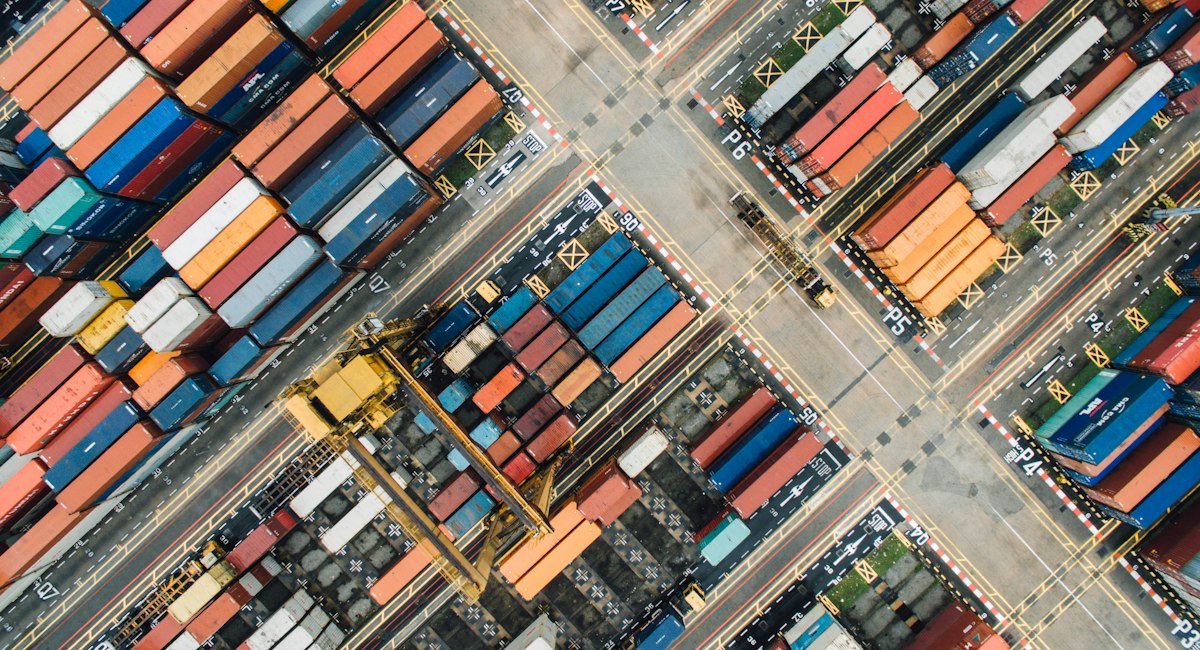 Aerial view of shipping containers arranged in a cargo yard